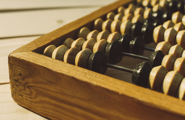 Old vintage abacus (calculating frame) close up shot, accounting abstract