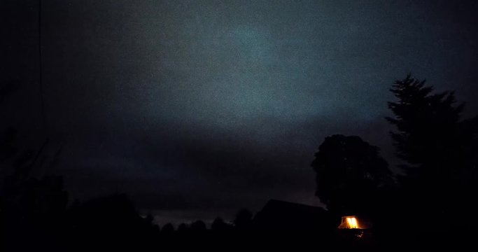Timelapse of stars over trees at summer night then clouds coming on dark sky. Timelapse. Starfall. Milky way. Tree on the foreground.