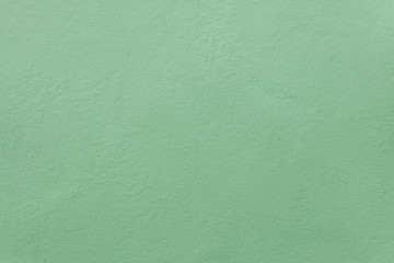 Green painted stucco wall.