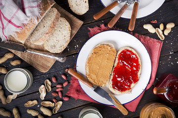 Peanut butter and jelly sandwich on a rustic table - Powered by Adobe