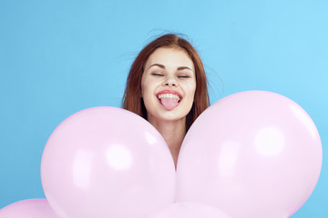 Fototapeta na wymiar Woman holding balloons, smiling