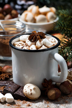 cup of hot chocolate with marshmallows and sweets on wooden table, closeup