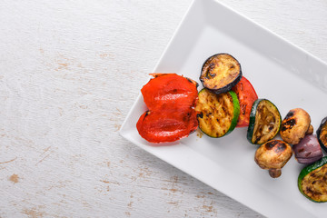 Grilled vegetables. On a wooden background. Top view. Free space for text.