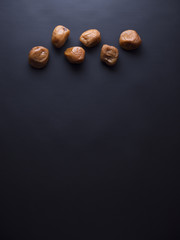 Umeboshi plums from Japan, fermented and salted and placed in a honey syrup. Isolated on black background
