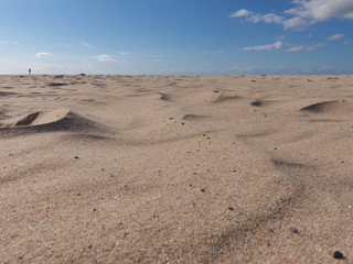 Strandmakro im Wüstenlook mit kleinem Menschen am Horizont