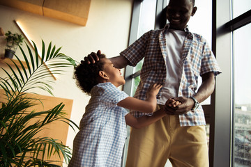 african american father and son having fun