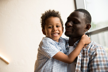 african american father and child hugging