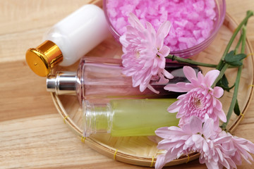 Skin cream, shampoo, salt spa and flower On a wooden background. Spa Concept.