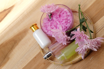 Skin cream, shampoo, salt spa and flower On a wooden background. Spa Concept.