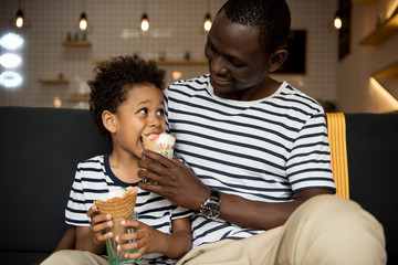 father and son eating ice cream - Powered by Adobe