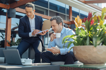 Serious thoughtful businessman taking notes