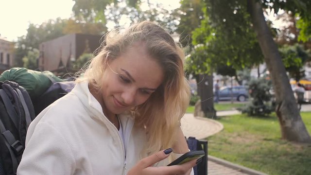 Touch phone sms writing, young woman girl in park bench