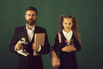 Man and girl and school uniform. Teacher and schoolgirl