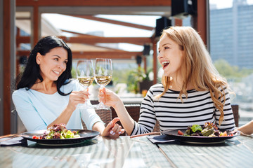 Happy positive women drinking wine