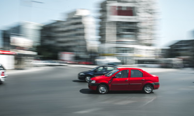 Fototapeta na wymiar Red car in motion