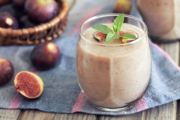 Fig smoothie served in glass with mint leaves