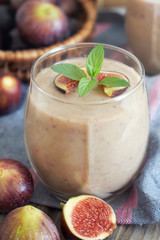 Fig smoothie served in glass with mint leaves