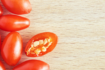 Fresh ripe goji berries on wooden background. Top view with copy space