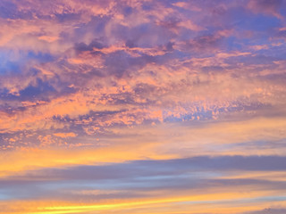 Naklejka na ściany i meble Beautiful sun rays of sunset with colorful of sky background