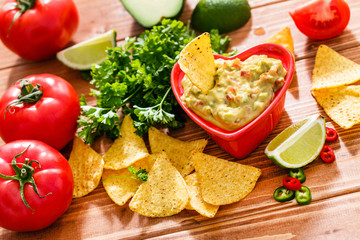Guacamole with avocado, lime, tomato, and cilantro