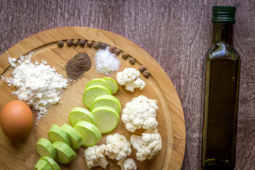 Fresh vegetables ready for roast. Top view. Wooden background