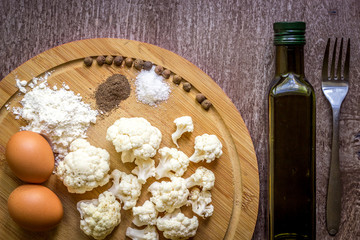 Healthy eating, vegetarian food. Raw cauliflower prepared for frying in a frying pan with spices in olive oil