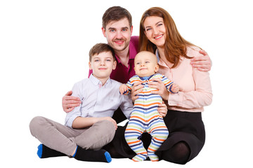 Happy and smiles Family with children and infant on a white background isolated, sitting on the floor