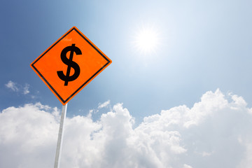 orange diamond traffic sign dollar in blue sunny sky
