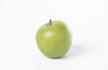 closeup single fresh green apple isolated on white background.