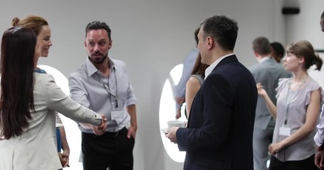 Business executives shaking hands at a networking event - Powered by Adobe