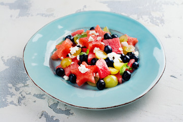 Fresh summer watermelon salad with blueberry and grapes. Copy space