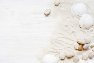 Fototapeta na wymiar White wooden background with sand, pebble and shells