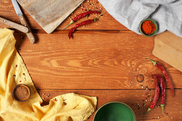 Wooden background with kitchen utensils and spices