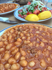 cooked haricot bean with tomato sauce on table
