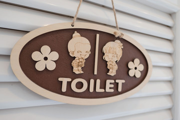 wooden toilet sign , Cute boy and girl  on White background .