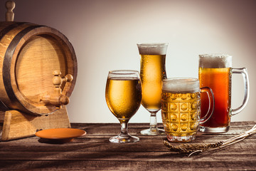 barrel and different beer in glasses
