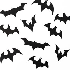 Handmade black paper bats for Halloween holiday on white background. Flat lay, top view.