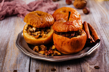 Baked apples stuffed with honey, raisin and nuts. Autumn dessert. Copy space