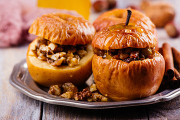 Baked apples stuffed with honey, raisin and nuts. Autumn dessert. Copy space