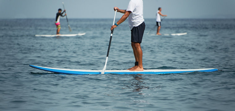 Stand Up Paddle Group On The Sea