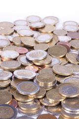 Many euro coins on white background.