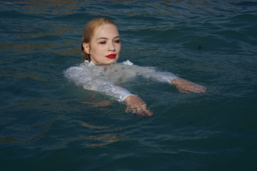 Fototapeta na wymiar business woman swim in the sea