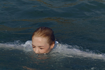 business woman sinking into the sea