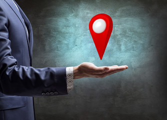 Businessman holding indicating location icon.