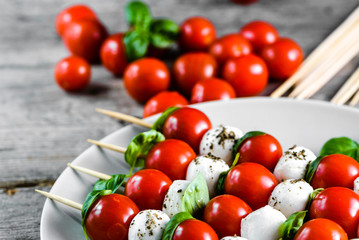 Caprese salad - mozzarella basil and tomato skewers, italian food and healthy vegetarian diet concept