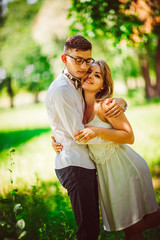Young beautiful couple on a blurred natural background