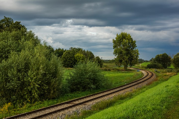 Fototapeta na wymiar View on the railroad tracks and trees in Poland