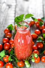 Bottle of tomato juice and fresh tomatoes, organic healthy food concept