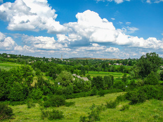 Obraz premium The Summer rural landscape amidst beautiful clouds