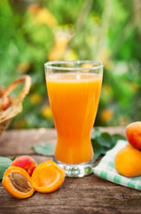 Glass of apricot juice and ripe apricots